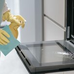 service-person-cleaning-kitchen-appliances_259150-59445